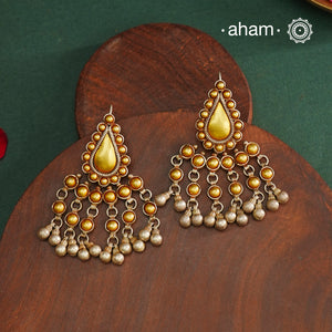 Enhance your style with the timeless elegance of the Dual Tone Silver Earrings. Handcrafted by skilled karigars in Barmer, Rajasthan, this earring features traditional Bandhel work, where a thin sheet of hand beaten&nbsp;22 carat gold is fused with 92.5 silver and then set on 92.5 silver using a unique wax filling technique. A classic representation of Indian craftsmanship.