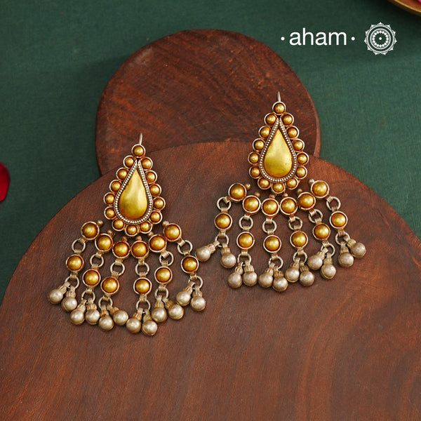 Enhance your style with the timeless elegance of the Dual Tone Silver Earrings. Handcrafted by skilled karigars in Barmer, Rajasthan, this earring features traditional Bandhel work, where a thin sheet of hand beaten&nbsp;22 carat gold is fused with 92.5 silver and then set on 92.5 silver using a unique wax filling technique. A classic representation of Indian craftsmanship.