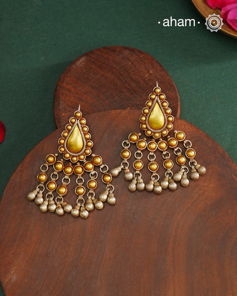 Enhance your style with the timeless elegance of the Dual Tone Silver Earrings. Handcrafted by skilled karigars in Barmer, Rajasthan, this earring features traditional Bandhel work, where a thin sheet of hand beaten&nbsp;22 carat gold is fused with 92.5 silver and then set on 92.5 silver using a unique wax filling technique. A classic representation of Indian craftsmanship.