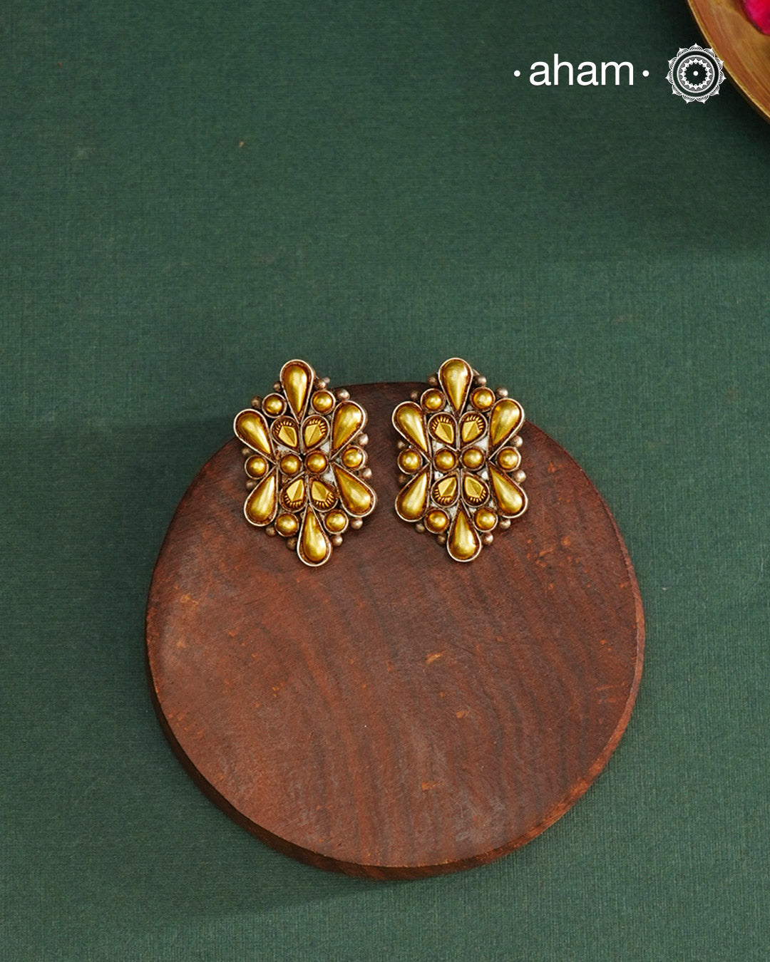 Enhance your style with the timeless elegance of the Dual Tone Silver Earrings. Handcrafted by skilled karigars in Barmer, Rajasthan, this earring features traditional Bandhel work, where a thin sheet of hand beaten 22 carat gold is fused with 92.5 silver and then set on 92.5 silver using a unique wax filling technique. A classic representation of Indian craftsmanship.
