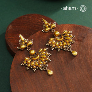 Enhance your style with the timeless elegance of the Dual Tone Silver Earrings. Handcrafted by skilled karigars in Barmer, Rajasthan, this earring features traditional Bandhel work, where a thin sheet of hand beaten 22 carat gold is fused with 92.5 silver and then set on 92.5 silver using a unique wax filling technique. A classic representation of Indian craftsmanship.
