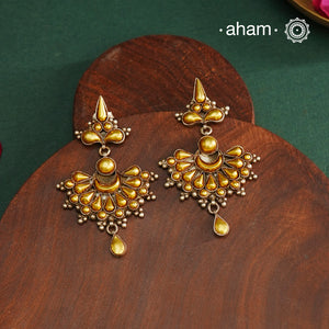 Enhance your style with the timeless elegance of the Dual Tone Silver Earrings. Handcrafted by skilled karigars in Barmer, Rajasthan, this earring features traditional Bandhel work, where a thin sheet of hand beaten 22 carat gold is fused with 92.5 silver and then set on 92.5 silver using a unique wax filling technique. A classic representation of Indian craftsmanship.