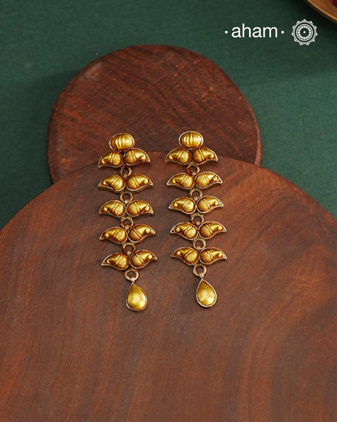 Enhance your style with the timeless elegance of the Dual Tone Silver Earrings. Handcrafted by skilled karigars in Barmer, Rajasthan, this earring features traditional Bandhel work, where a thin sheet of hand beaten 22 carat gold is fused with 92.5 silver and then set on 92.5 silver using a unique wax filling technique. A classic representation of Indian craftsmanship.