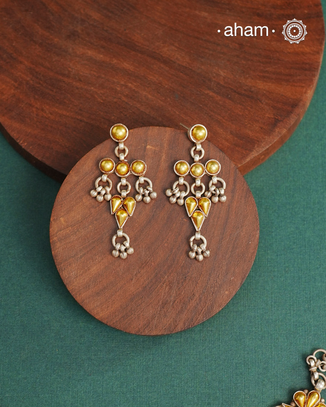 Enhance your style with the timeless elegance of the Dual Tone Silver Earrings. Handcrafted by skilled karigars in Barmer, Rajasthan, this earring features traditional Bandhel work, where a thin sheet of hand beaten 22 carat gold is fused with 92.5 silver and then set on 92.5 silver using a unique wax filling technique. A classic representation of Indian craftsmanship.