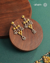 Enhance your style with the timeless elegance of the Dual Tone Silver Earrings. Handcrafted by skilled karigars in Barmer, Rajasthan, this earring features traditional Bandhel work, where a thin sheet of hand beaten 22 carat gold is fused with 92.5 silver and then set on 92.5 silver using a unique wax filling technique. A classic representation of Indian craftsmanship.
