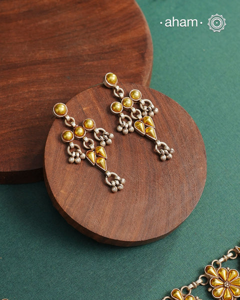 Enhance your style with the timeless elegance of the Dual Tone Silver Earrings. Handcrafted by skilled karigars in Barmer, Rajasthan, this earring features traditional Bandhel work, where a thin sheet of hand beaten 22 carat gold is fused with 92.5 silver and then set on 92.5 silver using a unique wax filling technique. A classic representation of Indian craftsmanship.