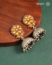 Enhance your style with the timeless elegance of the Dual Tone Silver Earrings. Handcrafted by skilled karigars in Barmer, Rajasthan, this earring features traditional Bandhel work, where a thin sheet of hand beaten 22 carat gold is fused with 92.5 silver and then set on 92.5 silver using a unique wax filling technique. A classic representation of Indian craftsmanship.