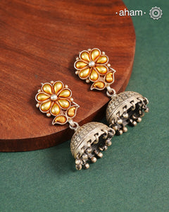 Enhance your style with the timeless elegance of the Dual Tone Silver Earrings. Handcrafted by skilled karigars in Barmer, Rajasthan, this earring features traditional Bandhel work, where a thin sheet of hand beaten 22 carat gold is fused with 92.5 silver and then set on 92.5 silver using a unique wax filling technique. A classic representation of Indian craftsmanship.