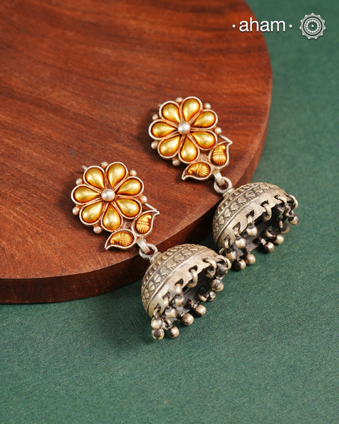 Enhance your style with the timeless elegance of the Dual Tone Silver Earrings. Handcrafted by skilled karigars in Barmer, Rajasthan, this earring features traditional Bandhel work, where a thin sheet of hand beaten 22 carat gold is fused with 92.5 silver and then set on 92.5 silver using a unique wax filling technique. A classic representation of Indian craftsmanship.