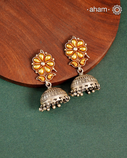 Enhance your style with the timeless elegance of the Dual Tone Silver Earrings. Handcrafted by skilled karigars in Barmer, Rajasthan, this earring features traditional Bandhel work, where a thin sheet of hand beaten 22 carat gold is fused with 92.5 silver and then set on 92.5 silver using a unique wax filling technique. A classic representation of Indian craftsmanship.