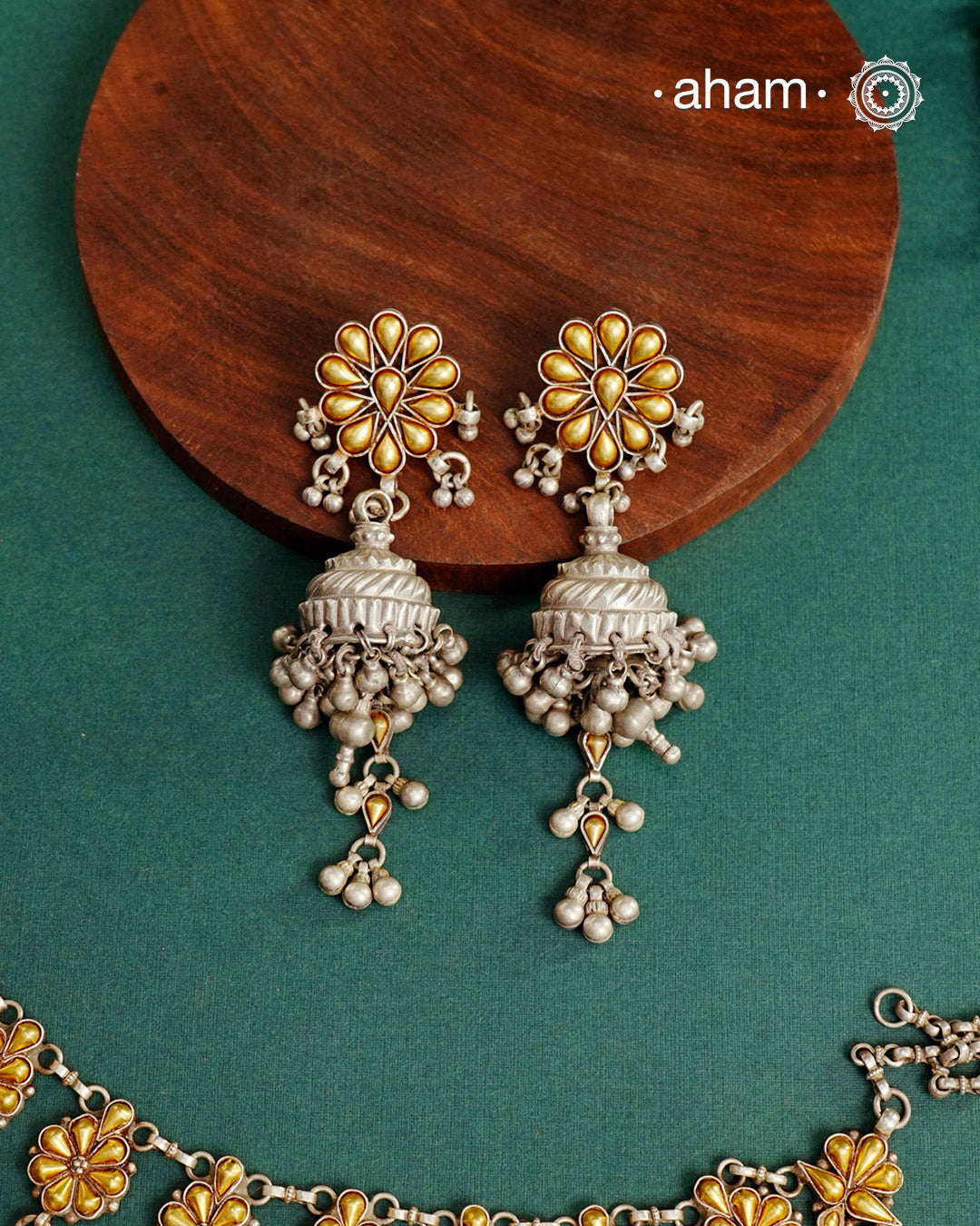 Enhance your style with the timeless elegance of the Dual Tone Silver Earrings. Handcrafted by skilled karigars in Barmer, Rajasthan, this earring features traditional Bandhel work, where a thin sheet of hand beaten 22 carat gold is fused with 92.5 silver and then set on 92.5 silver using a unique wax filling technique. A classic representation of Indian craftsmanship.
