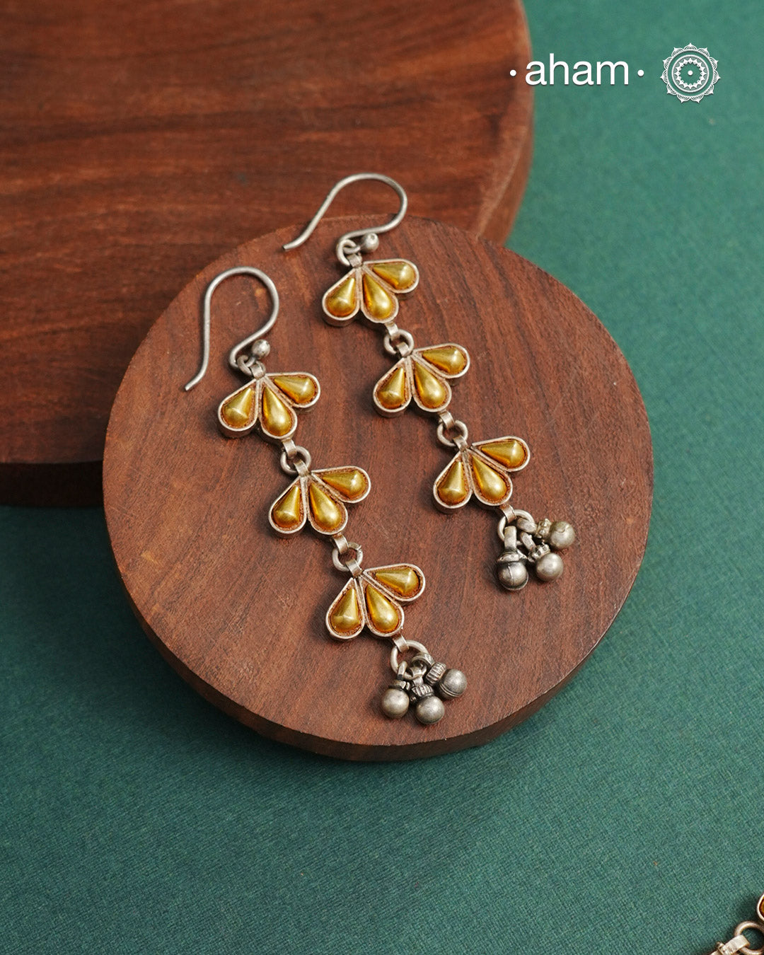 Enhance your style with the timeless elegance of the Dual Tone Silver Earrings. Handcrafted by skilled karigars in Barmer, Rajasthan, this earring features traditional Bandhel work, where a thin sheet of hand beaten 22 carat gold is fused with 92.5 silver and then set on 92.5 silver using a unique wax filling technique. A classic representation of Indian craftsmanship.