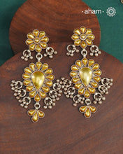 Enhance your style with the timeless elegance of the Dual Tone Silver Earrings. Handcrafted by skilled karigars in Barmer, Rajasthan, this earring features traditional Bandhel work, where a thin sheet of hand beaten 22 carat gold is fused with 92.5 silver and then set on 92.5 silver using a unique wax filling technique. A classic representation of Indian craftsmanship.&nbsp;