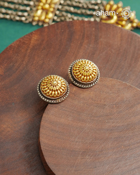 Enhance your style with the timeless elegance of the Dual Tone Silver Earrings. Handcrafted by skilled karigars in Barmer, Rajasthan, this earring features traditional Bandhel work, where a thin sheet of hand beaten 22 carat gold is fused with 92.5 silver and then set on 92.5 silver using a unique wax filling technique. A classic representation of Indian craftsmanship.