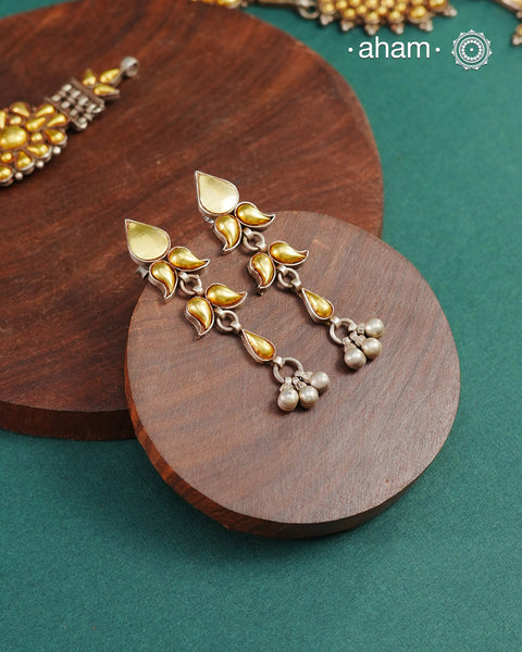 Enhance your style with the timeless elegance of the Dual Tone Silver Earrings. Handcrafted by skilled karigars in Barmer, Rajasthan, this earring features traditional Bandhel work, where a thin sheet of hand beaten 22 carat gold is fused with 92.5 silver and then set on 92.5 silver using a unique wax filling technique. A classic representation of Indian craftsmanship.&nbsp;