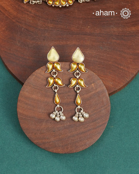 Enhance your style with the timeless elegance of the Dual Tone Silver Earrings. Handcrafted by skilled karigars in Barmer, Rajasthan, this earring features traditional Bandhel work, where a thin sheet of hand beaten 22 carat gold is fused with 92.5 silver and then set on 92.5 silver using a unique wax filling technique. A classic representation of Indian craftsmanship.&nbsp;