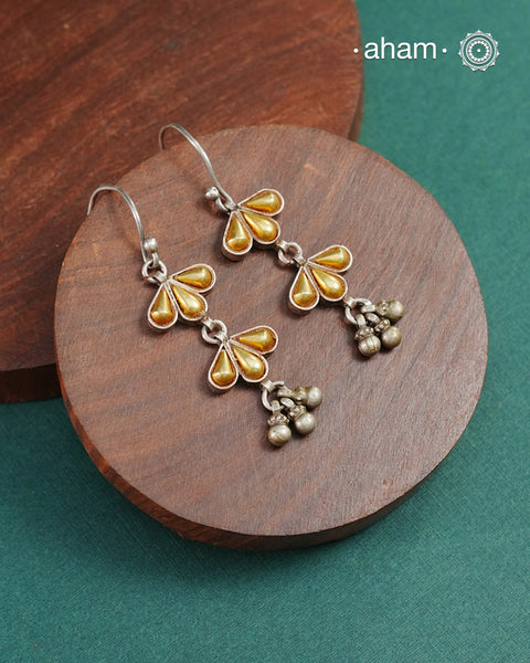 Enhance your style with the timeless elegance of the Dual Tone Silver Earrings. Handcrafted by skilled karigars in Barmer, Rajasthan, this earring features traditional Bandhel work, where a thin sheet of hand beaten 22 carat gold is fused with 92.5 silver and then set on 92.5 silver using a unique wax filling technique. A classic representation of Indian craftsmanship.&nbsp;