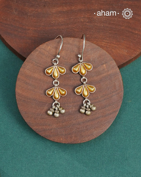 Enhance your style with the timeless elegance of the Dual Tone Silver Earrings. Handcrafted by skilled karigars in Barmer, Rajasthan, this earring features traditional Bandhel work, where a thin sheet of hand beaten 22 carat gold is fused with 92.5 silver and then set on 92.5 silver using a unique wax filling technique. A classic representation of Indian craftsmanship.