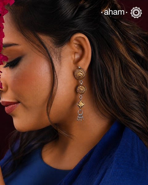 Enhance your style with the timeless elegance of the Dual Tone Silver Earrings. Handcrafted by skilled karigars in Barmer, Rajasthan, this earring features traditional Bandhel work, where a thin sheet of hand beaten 22 carat gold is fused with 92.5 silver and then set on 92.5 silver using a unique wax filling technique. A classic representation of Indian craftsmanship.&nbsp;