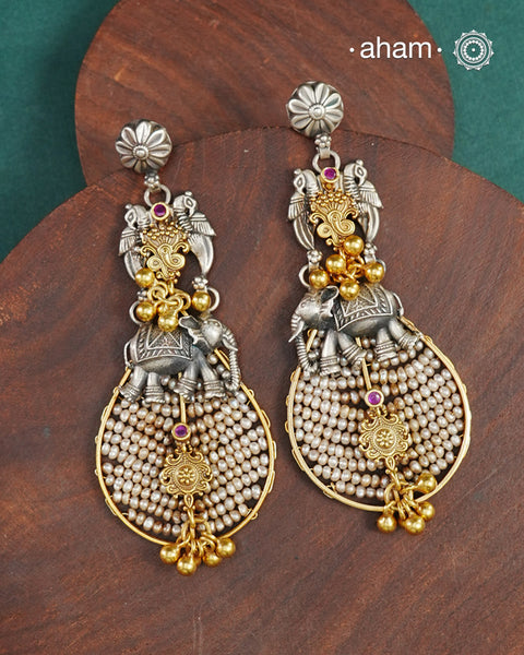 Noori two tone earrings handcrafted in 92.5 sterling silver with pearl, kundan and gold highlights. Style this up with your favourite ethnic or fusion outfits to complete the look.