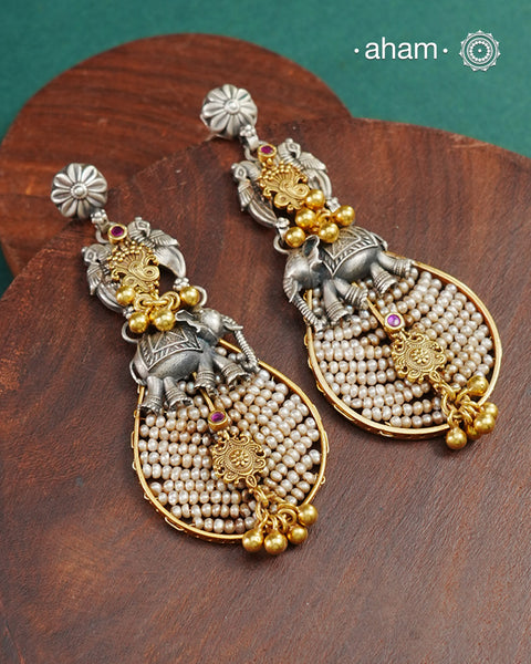 Noori two tone earrings handcrafted in 92.5 sterling silver with pearl, kundan and gold highlights. Style this up with your favourite ethnic or fusion outfits to complete the look.