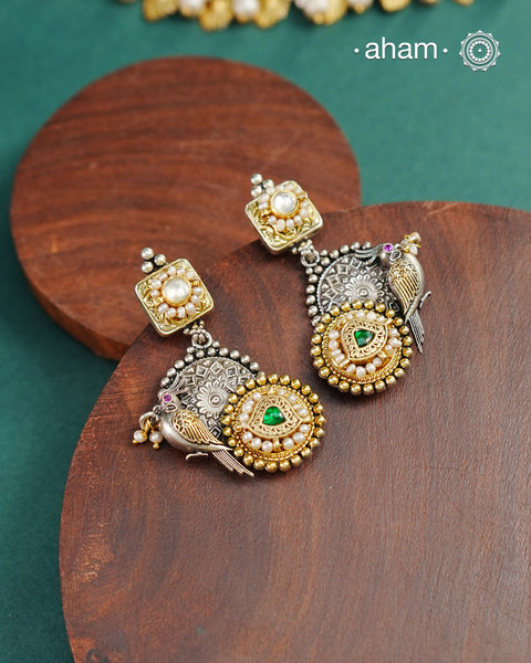 Noori two tone Earrings. The earrings are handcrafted in 92.5 sterling silver with kundan and gold highlights.Style this up with your favourite ethnic or fusion outfits to complete the look.
