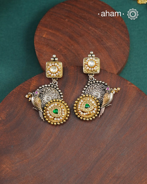 Noori two tone Earrings. The earrings are handcrafted in 92.5 sterling silver with kundan and gold highlights.Style this up with your favourite ethnic or fusion outfits to complete the look.
