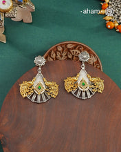 Noori two tone Peacock Earrings handcrafted in 92.5 sterling silver with kundan and gold highlights.Style this up with your favourite ethnic or fusion outfits to complete the look.