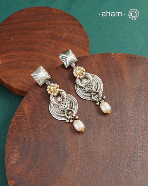 Noori two tone earrings handcrafted in 92.5 sterling silver with kundan and gold highlights. Style this up with your favourite ethnic or fusion outfits to complete the look.
