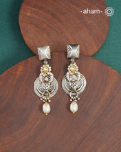 Noori two tone earrings handcrafted in 92.5 sterling silver with kundan and gold highlights. Style this up with your favourite ethnic or fusion outfits to complete the look.