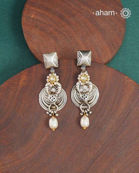 Noori two tone earrings handcrafted in 92.5 sterling silver with kundan and gold highlights. Style this up with your favourite ethnic or fusion outfits to complete the look.
