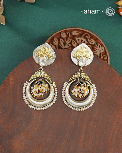Noori two tone Earrings handcrafted in 92.5 sterling silver with kundan and gold highlights.Style this up with your favourite ethnic or fusion outfits to complete the look.