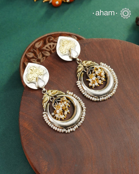 Noori two tone Earrings handcrafted in 92.5 sterling silver with kundan and gold highlights.Style this up with your favourite ethnic or fusion outfits to complete the look.