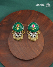 Noori two tone Earrings handcrafted in 92.5 sterling silver with kundan and gold highlights and a beautiful green carved stone. Style this up with your favourite ethnic or fusion outfits to complete the look.