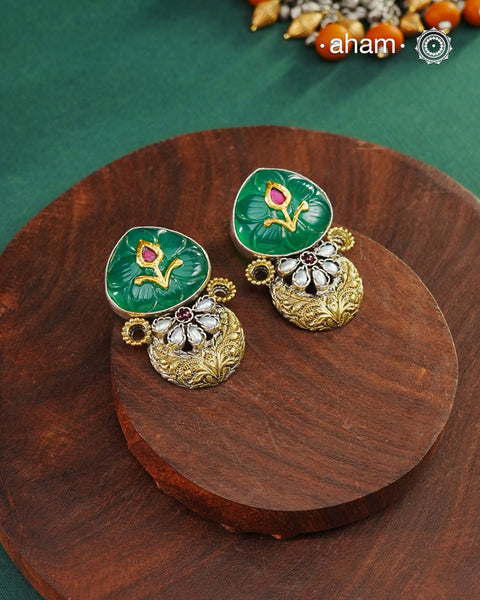 Noori two tone Earrings handcrafted in 92.5 sterling silver with kundan and gold highlights and a beautiful green carved stone. Style this up with your favourite ethnic or fusion outfits to complete the look.