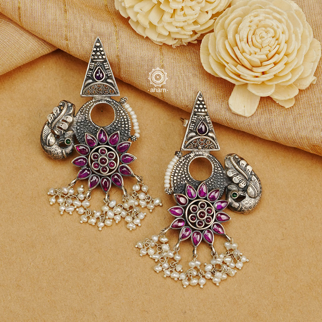 Handcrafted 92.5 sterling Silver earring from our Malhar collection. Hand silver work, with kemp stone highlights laced with pearls 