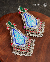 This Meena Work Festive Silver earrings is a stunning piece of jewellery perfect for special occasions. It features a combination of kundan and pearls with very contemporary enamelling work all crafted in 92.5 silver.