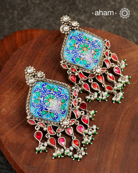 This Meena Work Festive Silver earrings is a stunning piece of jewellery perfect for special occasions.&nbsp;It features a combination of kundan and pearls with very contemporary enamelling work, all crafted in 92.5 silver.