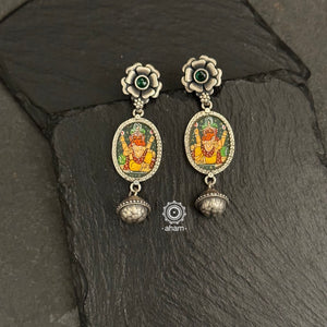 Light weight silver earrings with intricate miniature hand painted Ganesha motif in vibrant colours, enclosed with a glass top.