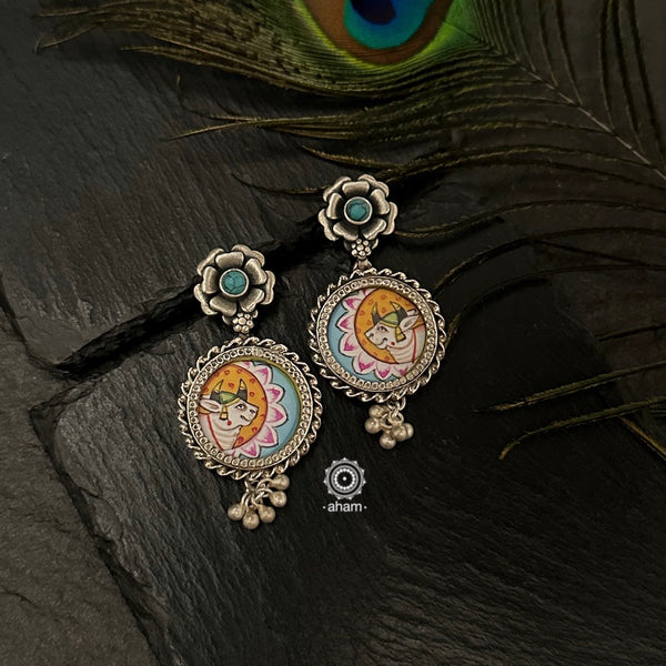 Hand painted silver drop earrings with intricate Pichwai miniature painting done by skilful artisans enclosed with a glass top. Perfect everyday wear earrings. 