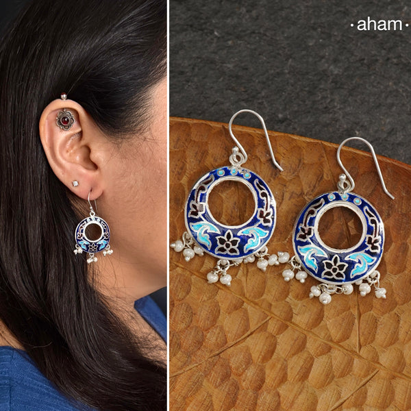 Elevate your style with our Meena Work Silver Earrings. Handcrafted in 92.5 silver, these earrings feature traditional meenawork, adding intricate detail to your ensemble. Enhance your look with this elegant and timeless accessory.
