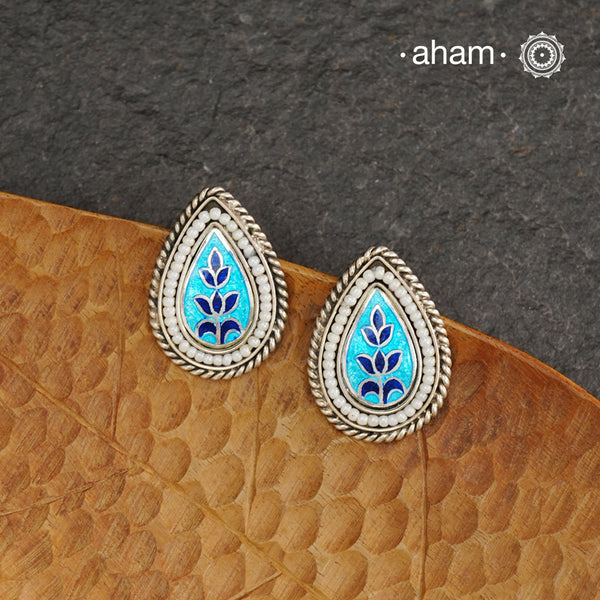 Elevate your style with our Meena Work Silver Earrings. Handcrafted in 92.5 silver, these earrings feature traditional meenawork, adding intricate detail to your ensemble. Enhance your look with this elegant and timeless accessory.