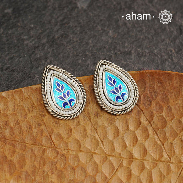 Elevate your style with our Meena Work Silver Earrings. Handcrafted in 92.5 silver, these earrings feature traditional meenawork, adding intricate detail to your ensemble. Enhance your look with this elegant and timeless accessory.