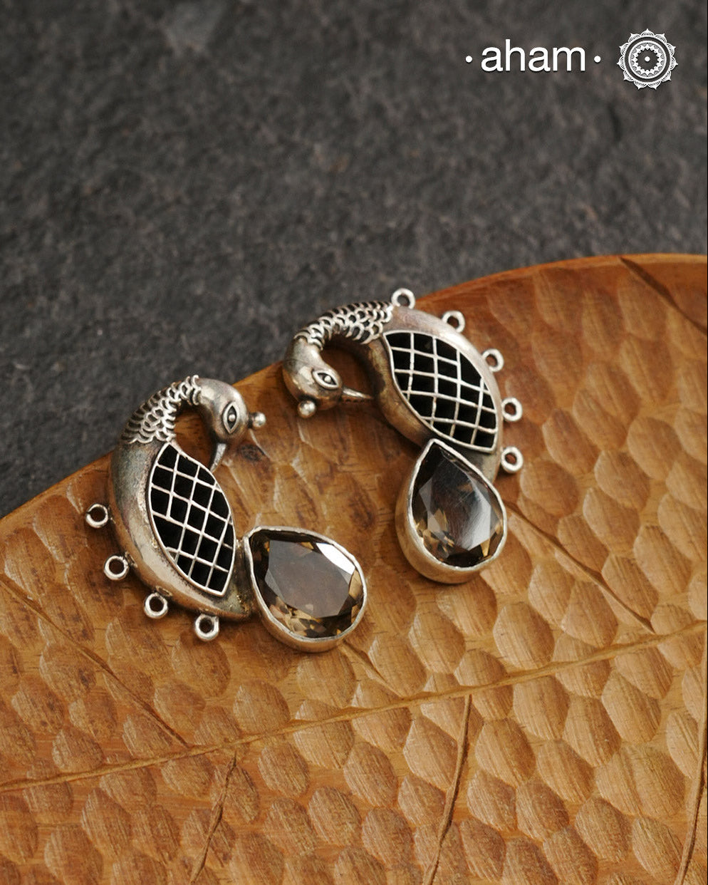 Handcrafted 92.5 sterling silver Ira earrings. Intricate peacock motif with a beautiful red brown stone drop. Perfect as casual and work wear.