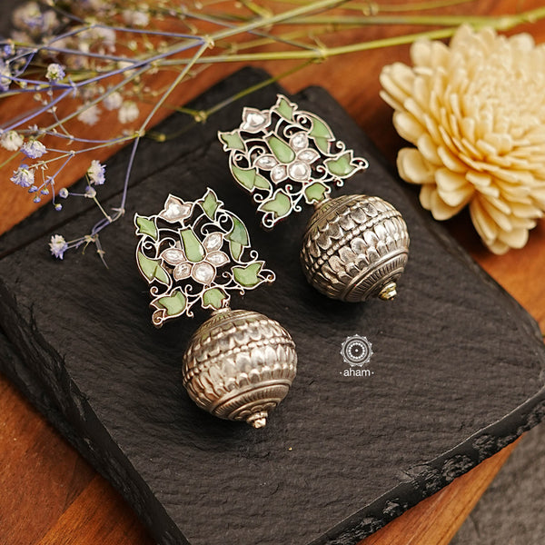 Make a statement with these stunning Ira Drop Silver Earrings. Handcrafted in 92.5 sterling silver, the earring is adorned with an elegant muted green stone setting for a sophisticated look. Wear these earrings to gracefully transition between traditional and contemporary fashion.