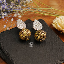Brighten your looks with these fashionable Ira Drop Silver Earrings; crafted in 92.5 sterling silver, made of dual tones with a chitai ball and kundan top. Perfect for elevating your wardrobe, these earrings add the perfect touch of glitz and glamour.