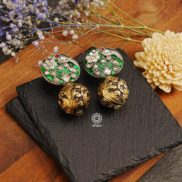 These dual-tone Ira Drop Silver Earrings are exquisitely crafted in 92.5 silver and feature beautiful green kundan work and chitai ball drop accents. With a combination of classic design and fine craftsmanship, these earrings will stand out in any ensemble.