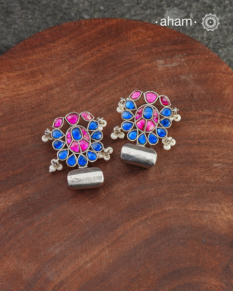 Ira&nbsp;drop&nbsp;earrings with elegant Blue and pink kundan. Handcrafted in 92.5 sterling silver with&nbsp;semi precious stone setting. Can be paired with both ethnic and western outfits.