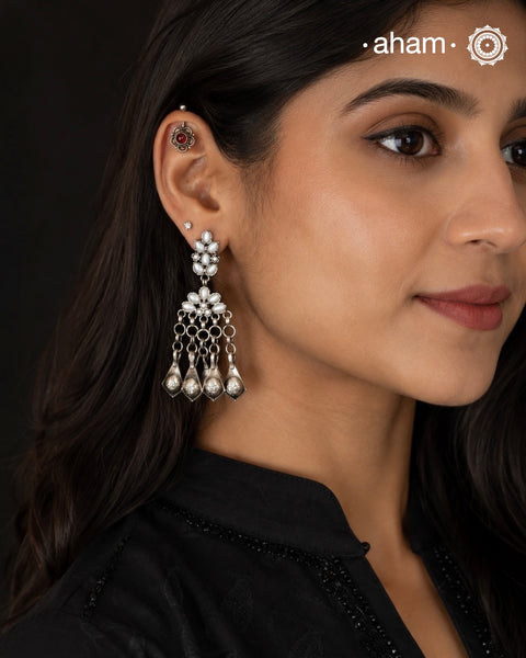 These handcrafted Ira earrings are made from 92.5 sterling silver, making them a stunning addition to any outfit. The stunning pearl work and statement Ghungroos make these earrings perfect for special occasions and festivities. Elevate your look with these exquisite and unique earrings.