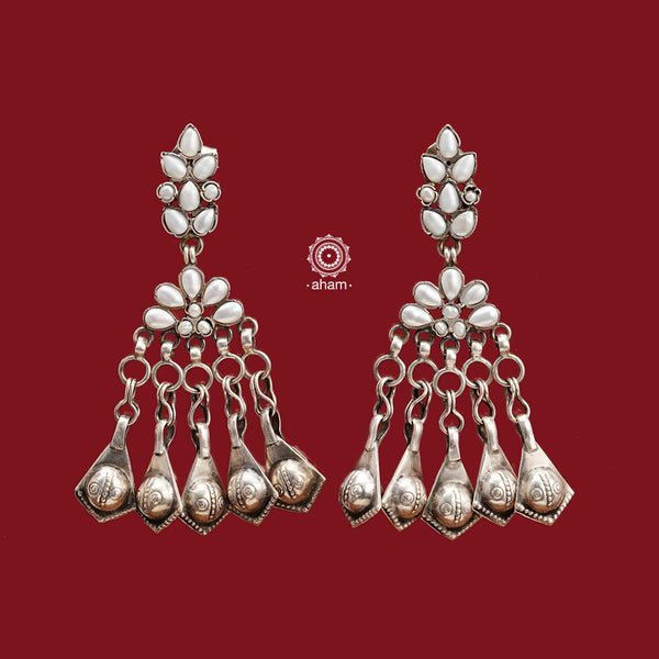 These handcrafted Ira earrings are made from 92.5 sterling silver, making them a stunning addition to any outfit. The stunning pearl work and statement Ghungroos make these earrings perfect for special occasions and festivities. Elevate your look with these exquisite and unique earrings.